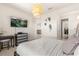 Bedroom features a mounted TV, modern dresser, and doorway to walk-in closet and upstairs landing at 2613 Mead Ave, St Cloud, FL 34771