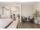 Comfortable bedroom with stylish green chairs, plant accents, and a view into an office at 2613 Mead Ave, St Cloud, FL 34771