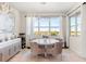 Bright dining room featuring a modern chandelier, round table, and a large window with scenic views at 2613 Mead Ave, St Cloud, FL 34771