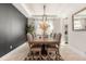 Dining room with a long wood table, decorative black wall, and stylish light fixture at 2613 Mead Ave, St Cloud, FL 34771