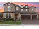 Beautiful two story home with a three-car garage, stone accents, and a well manicured front yard at 2613 Mead Ave, St Cloud, FL 34771