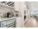 Modern kitchen with white cabinetry, stainless steel appliances, a wine fridge, and a wine rack at 2613 Mead Ave, St Cloud, FL 34771