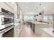 Bright kitchen featuring a large island, modern appliances, and abundant countertop space with views to the living spaces at 2613 Mead Ave, St Cloud, FL 34771