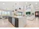 Open-concept kitchen with a large island and views of the living and dining areas, offering a bright and inviting space at 2613 Mead Ave, St Cloud, FL 34771