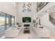 Elegant living room features a fireplace, large TV, and open staircase, creating an inviting and stylish ambiance at 2613 Mead Ave, St Cloud, FL 34771