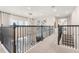 Spacious loft area with decorative railing, chandelier lighting, and views to the lower level at 2613 Mead Ave, St Cloud, FL 34771