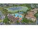 Aerial view of community amenities, including a resort-style pool, waterslides, and a scenic pond at 2621 Archfeld Blvd, Kissimmee, FL 34747