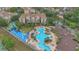 Aerial view of resort-style pool area with waterslides, surrounding buildings, and lush landscaping at 2621 Archfeld Blvd, Kissimmee, FL 34747