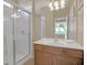 Bathroom featuring a glass enclosed shower, toilet, and a wood cabinet sink at 2621 Archfeld Blvd, Kissimmee, FL 34747