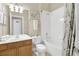 Bright bathroom with a single sink vanity, toilet, and a shower-tub combo with white tile at 2621 Archfeld Blvd, Kissimmee, FL 34747