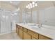 Well-lit bathroom featuring a double sink vanity and a glass-enclosed shower for convenience at 2621 Archfeld Blvd, Kissimmee, FL 34747