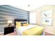 Inviting bedroom with grey headboard, yellow accents, and abstract artwork at 2621 Archfeld Blvd, Kissimmee, FL 34747