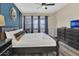 Charming bedroom featuring a king bed, accent wall, and a view of the backyard at 2621 Archfeld Blvd, Kissimmee, FL 34747