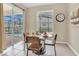 Cozy breakfast nook with table, overlooking the screened-in lanai and pool area, perfect for casual dining at 2621 Archfeld Blvd, Kissimmee, FL 34747
