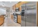 Modern kitchen featuring stainless steel appliances, granite countertops, tile flooring, and a functional layout at 2621 Archfeld Blvd, Kissimmee, FL 34747