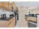 Spacious kitchen with stainless steel appliances, granite countertops, and tile flooring, ideal for cooking and entertaining at 2621 Archfeld Blvd, Kissimmee, FL 34747
