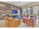 Comfortable living room with modern furnishings, tile floors, and a view of the screened-in lanai and pool at 2621 Archfeld Blvd, Kissimmee, FL 34747