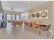 Open-concept living and dining area with tile floors, modern lighting, and a comfortable seating arrangement at 2621 Archfeld Blvd, Kissimmee, FL 34747