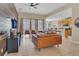 Open-concept living room featuring stylish wood accent wall, tile floors, and an open flow to the kitchen at 2621 Archfeld Blvd, Kissimmee, FL 34747