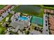 Aerial view of the community amenities with a pool, tennis courts, and a pond at 2943 Banana Palm Dr, Kissimmee, FL 34747