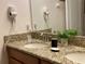 Well-lit bathroom featuring double sinks with granite countertops and mounted hair dryers at 2943 Banana Palm Dr, Kissimmee, FL 34747