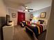 Bright bedroom with twin beds, ceiling fan, carpeting and wall decorations at 2943 Banana Palm Dr, Kissimmee, FL 34747