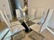 Modern dining room with a glass-top table, stylish chairs, and contemporary decor at 2943 Banana Palm Dr, Kissimmee, FL 34747
