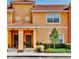 Charming two-story townhome with a terracotta tile roof and well-maintained landscaping at 2943 Banana Palm Dr, Kissimmee, FL 34747