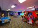 Spacious game room with arcade games, a pool table, and a carpeted floor at 2943 Banana Palm Dr, Kissimmee, FL 34747