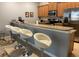 Kitchen bar with granite countertops, stainless steel appliances, and comfortable seating at 2943 Banana Palm Dr, Kissimmee, FL 34747