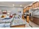 Open kitchen featuring granite countertops, stainless steel appliances, and a convenient breakfast bar at 2943 Banana Palm Dr, Kissimmee, FL 34747