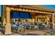 Covered outdoor dining area with ample seating for entertainment near the pool at 2943 Banana Palm Dr, Kissimmee, FL 34747
