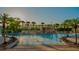 Resort-style pool featuring a waterfall and tropical landscaping, perfect for relaxation at 2943 Banana Palm Dr, Kissimmee, FL 34747