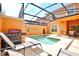 Screened-in patio with private pool, grill, and lounge chairs perfect for relaxation and outdoor enjoyment at 2943 Banana Palm Dr, Kissimmee, FL 34747