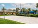 Sand volleyball court with blue canopies in a tropical-themed neighborhood at 2943 Banana Palm Dr, Kissimmee, FL 34747