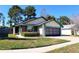 Charming single-story home with a well-maintained lawn, garage, and tidy landscaping at 3188 Owassa Ct, Kissimmee, FL 34746