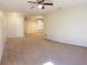 Neutral living room with carpet, ceiling fan, and views to dining room at 3188 Owassa Ct, Kissimmee, FL 34746