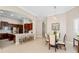 Open dining room with dark wood cabinets, breakfast bar, and a long table at 3205 Heirloom Rose Pl, Oviedo, FL 32766