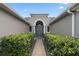 The home's entrance features a walkway lined with manicured hedges and a striking blue multi-light door at 3205 Heirloom Rose Pl, Oviedo, FL 32766