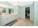 Bathroom showcases double sinks, walk in closet and a shower with a glass door at 4418 Blackbird St, Kissimmee, FL 34746