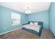 Bedroom with carpet floors, natural light from the window, a crystal chandelier and blue paint at 4418 Blackbird St, Kissimmee, FL 34746