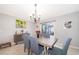 Dining area showcases table, chairs, sideboard, decor, and a sliding door leading to a screened patio at 4418 Blackbird St, Kissimmee, FL 34746