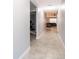 Inviting hallway with tiled floors leading to a living room and additional room, freshly painted in grey at 4418 Blackbird St, Kissimmee, FL 34746