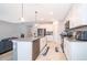 Contemporary kitchen featuring stainless steel appliances, an island with a sink, and light gray countertops at 4418 Blackbird St, Kissimmee, FL 34746