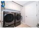 The laundry room features front loading washer and dryer and built in shelves above at 4418 Blackbird St, Kissimmee, FL 34746