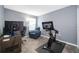 Spacious office featuring two desks, a chair and exercise bike set-up, and a window for natural light at 4418 Blackbird St, Kissimmee, FL 34746
