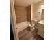 Updated bathroom featuring wood-look tile backsplash and flooring and a modern sink at 4903 Lake Ridge Rd # Ge, Orlando, FL 32808