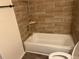 Updated bathroom featuring wood-look tile backsplash and flooring and a modern tub at 4903 Lake Ridge Rd # Ge, Orlando, FL 32808