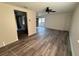Open-concept living room featuring luxury vinyl plank flooring and a ceiling fan at 4903 Lake Ridge Rd # Ge, Orlando, FL 32808