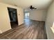 Spacious living room with modern flooring, abundant natural light, a ceiling fan, and access to the outside at 4903 Lake Ridge Rd # Ge, Orlando, FL 32808
